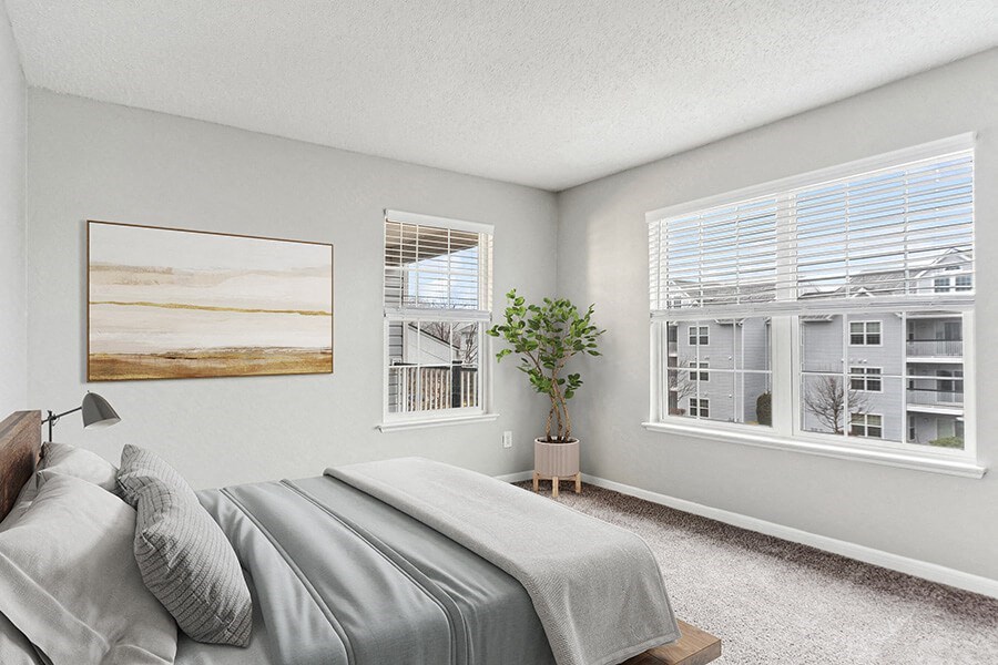Model Bedroom with Carpet and Window Views at Commons at Haynes Farm Apartments in Shrewsbury, MA.
