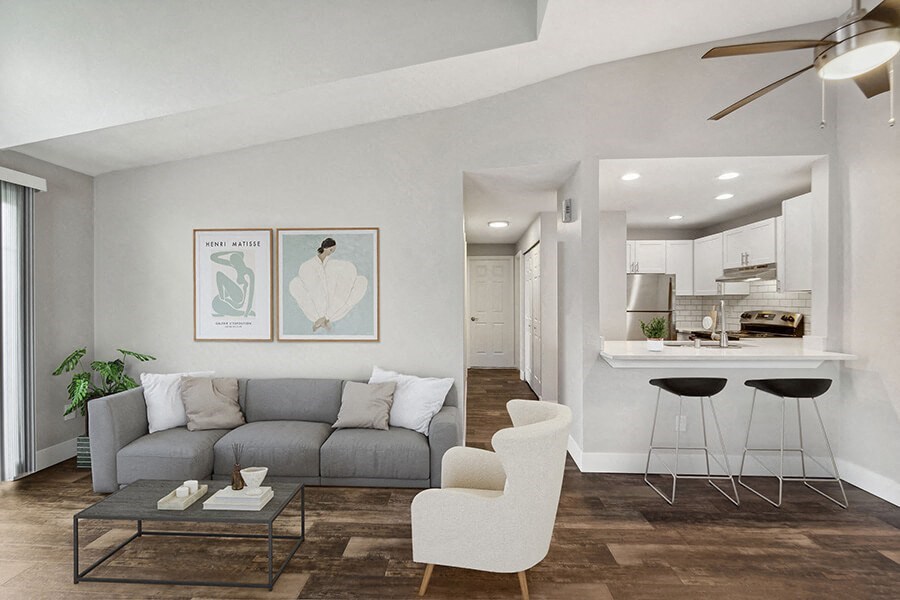 Model Living Room with Wood-Style Flooring, Patio Accessibility and View of Kitchen at Central Flats Apartments in Kent, WA.