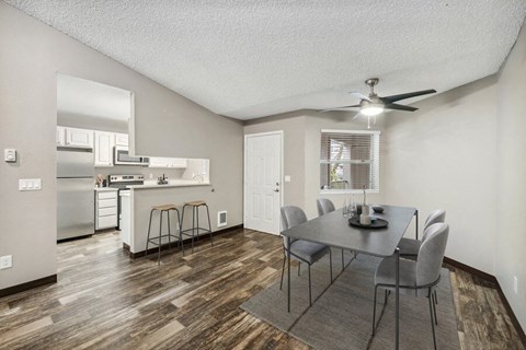 a kitchen and dining room with a table and chairs