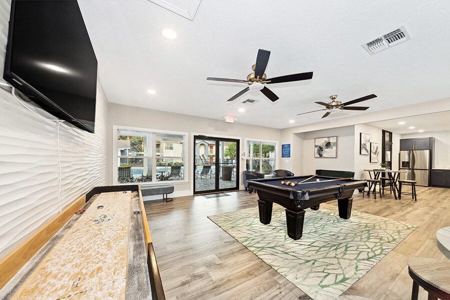 Community Clubhouse with Game Tables at Retreat at Crosstown Apartments in Riverview, FL.