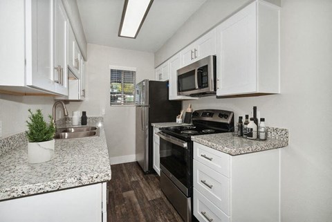 a kitchen with a stove and a microwave