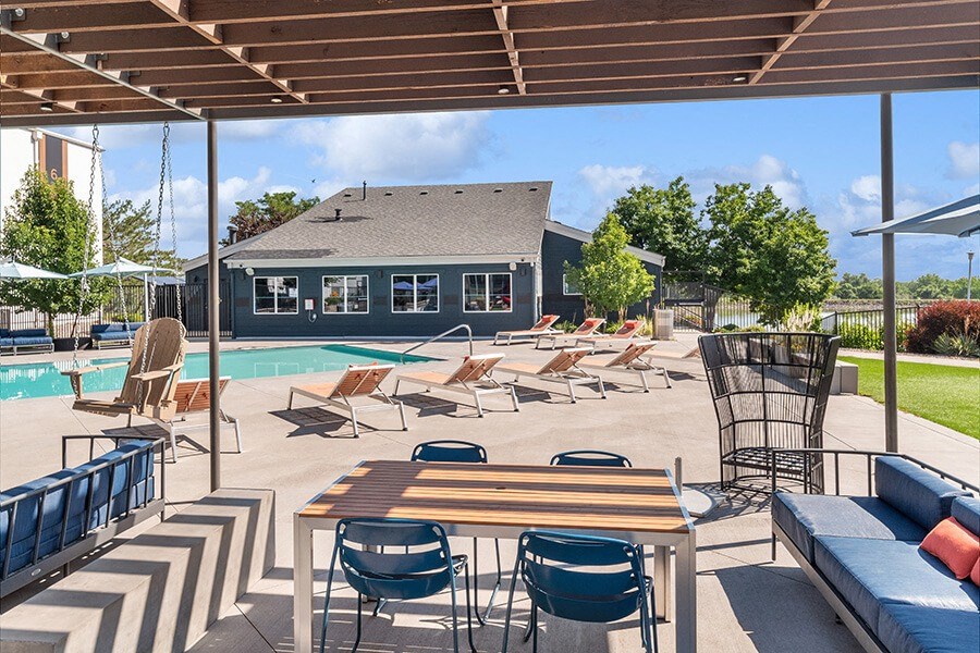 Community Swimming Pool with Pool Furniture at Waterfront Apartments in Lakewood, CO.