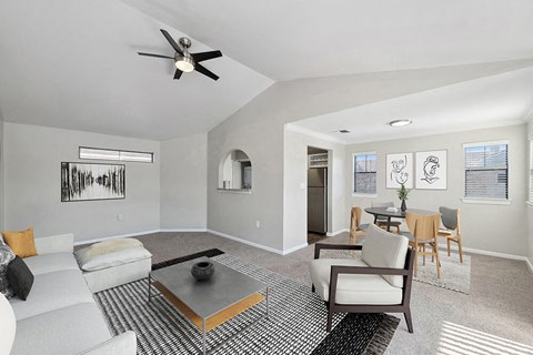 Model Living Room with Carpet and View of Dining Room at Hidden Creek Apartments in Lewisville, TX.