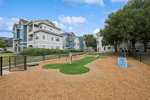 Community Dog Park with Agility Equipment at Hidden Creek Apartments located in Lewisville, TX.