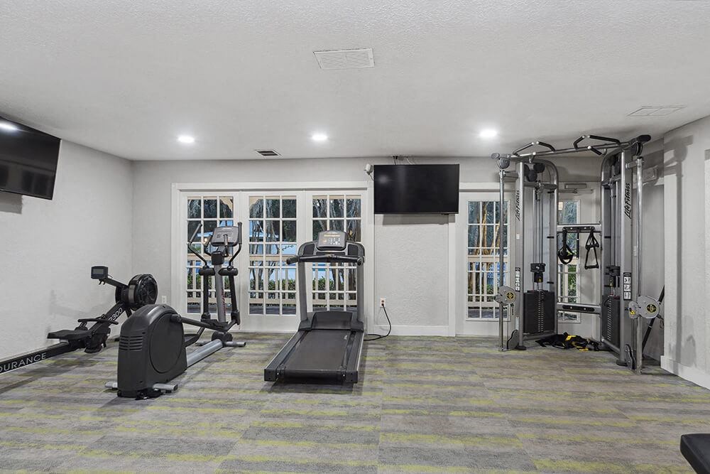 Community Fitness Center with Equipment at Walden Lake Apartments in Plant City, FL.