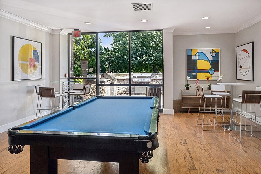 Community Clubhouse with Game Tables and Lounge Furniture at Mason Van Dorn Apartments located in Alexandria, VA.