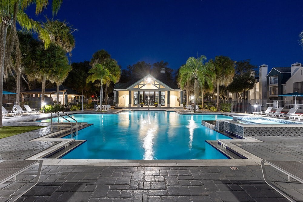 Community Swimming Pool with Pool Furniture at Caribbean Breeze Apartments in Tampa, FL.