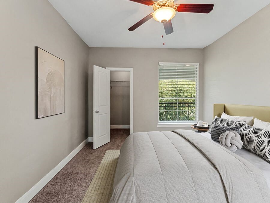 Model Bedroom with Carpet and Walk In Closet at Park West Apartments located in Houston, TX.