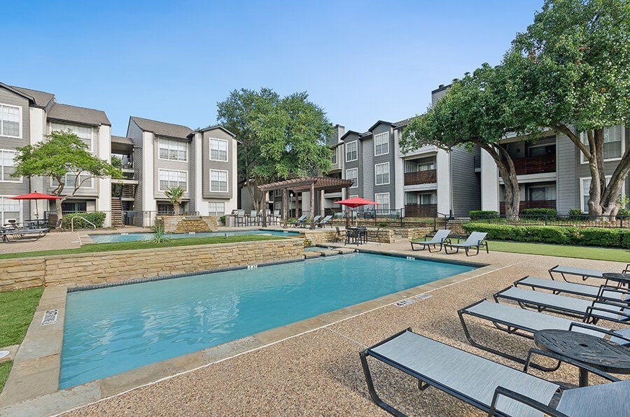 Community Swimming Pool with Pool Furniture at Cobblestone Apartments located in Arlington, TX.