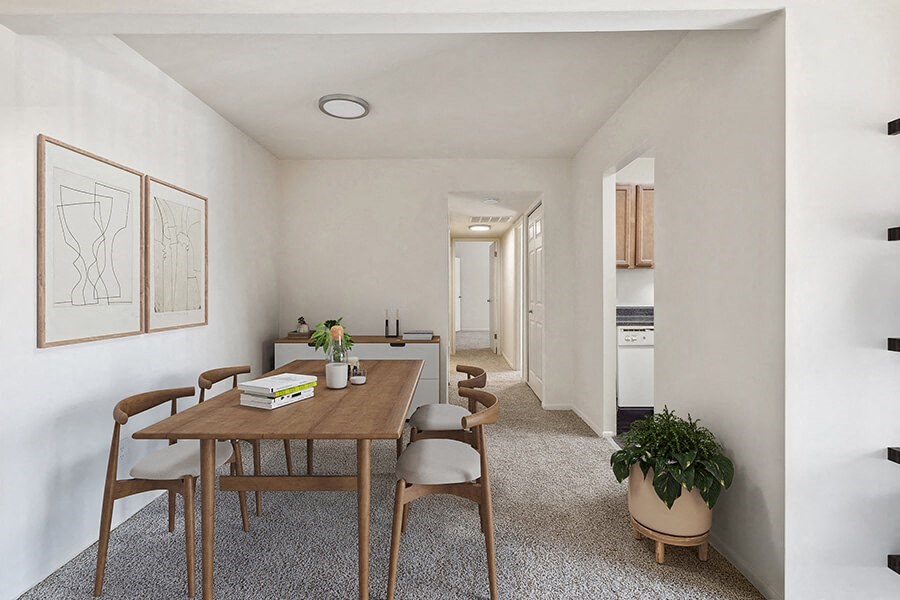 Model Dining Room with Carpet and View of Kitchen at Spring Parc Apartments in Silver Spring, MD.