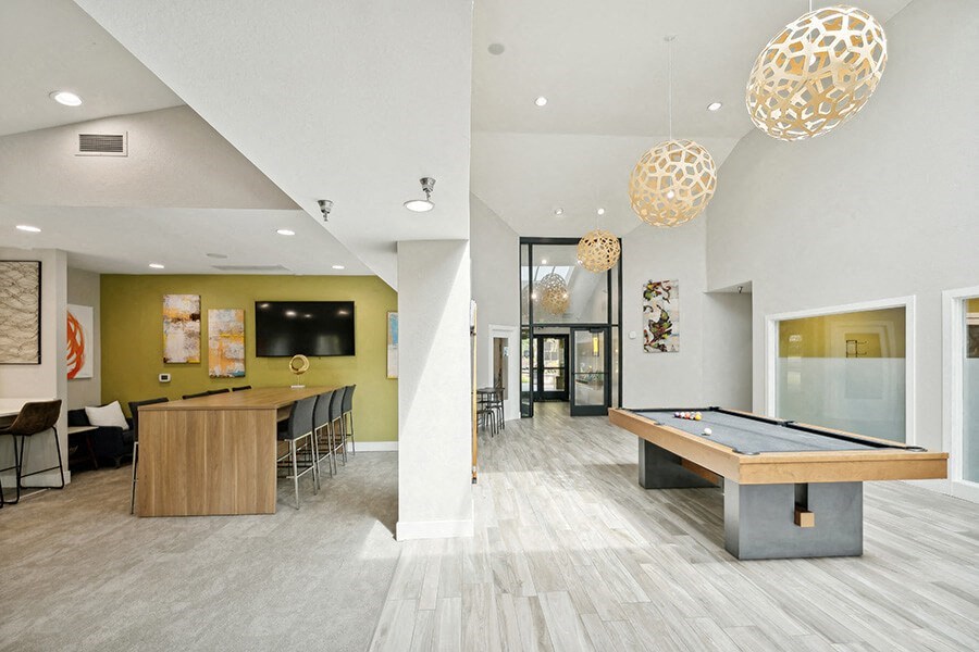 Community Clubhouse with Game Tables and Lounge Furniture at The Club Apartments located in Hillsboro, OR.