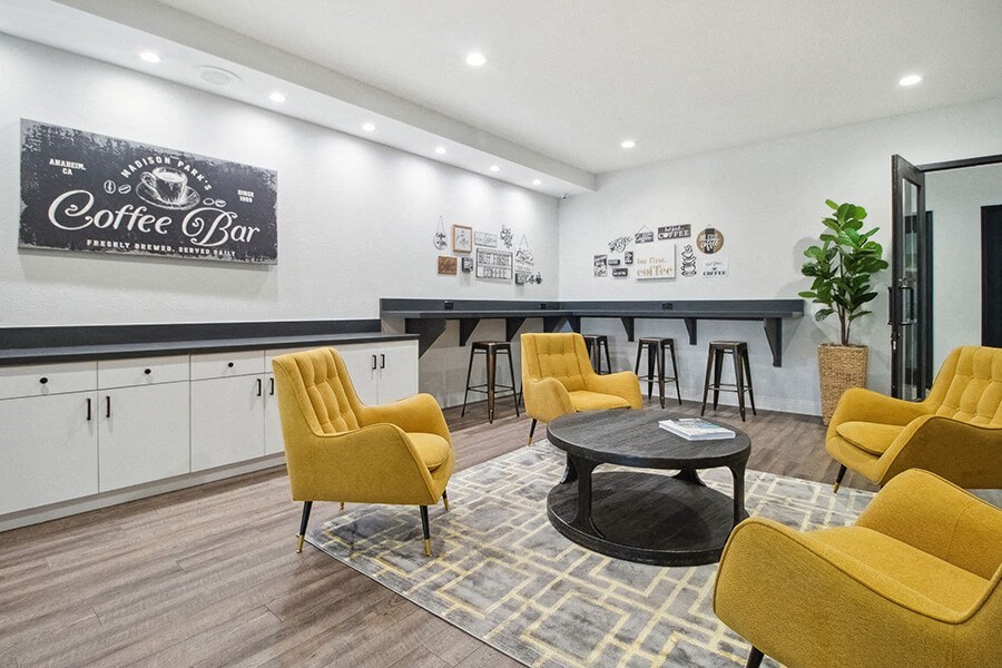 Community Clubhouse with Lounge Furniture at Madison Park Apartments located in Anaheim, CA.