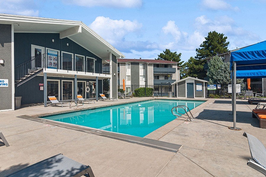 Community Swimming Pool with Pool Furniture at Monaco Apartments in Salt Lake City, UT.
