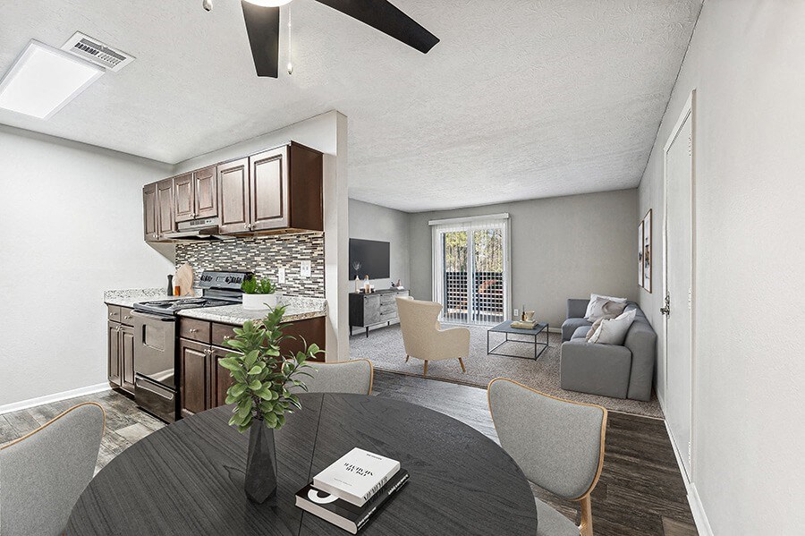 Model Dining Room and Kitchen Area with Wood-Style Flooring at Paramont Apartments in Duluth, GA.