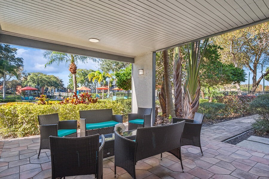 Outdoor Lounge Area with Covered Furniture at Bridges at Bayside Apartments in St. Petersburg, FL.
