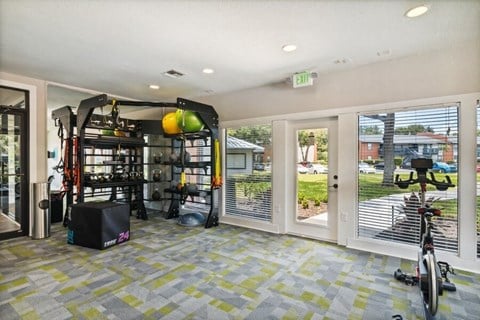 North St. Petersburg, FL, Apartments Near Pinellas Park High School - Bridges at Bayside - A Fitness Center With A Training Rack, Medicine Balls, Resistance Bands, And Stationary Bike.