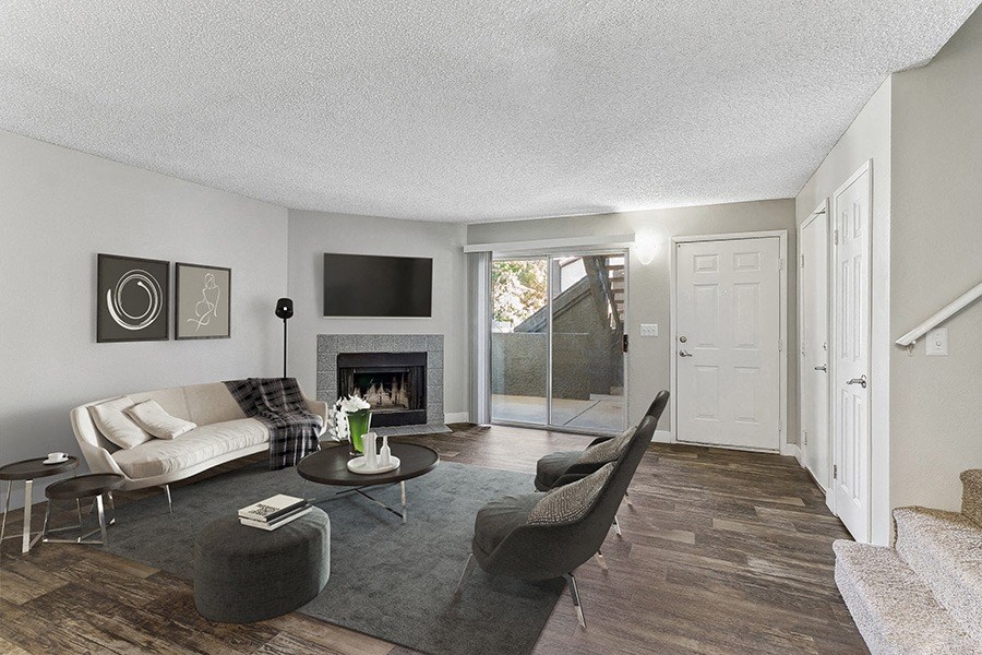 Model Living Room with Wood-Style Flooring and Patio Accessibility at Meadow Ridge Apartments in Las Vegas, NV.