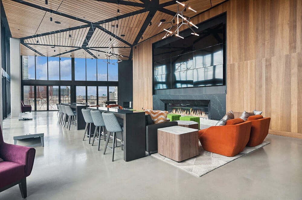 Impressive resident lobby space with large fireplace and multi-display tv at Post District Residences in Downtown Salt Lake City, Utah