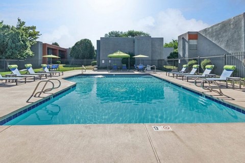 Community Swimming Pool with Pool Furniture at Indigo Park Apartments in Albuquerque, NM.