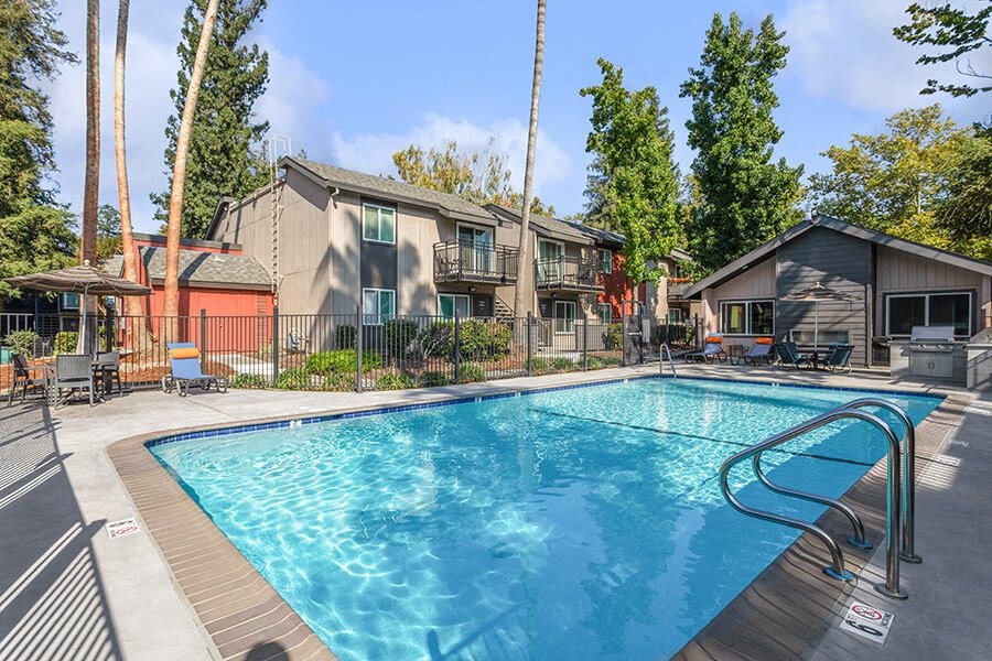 Community Swimming Pool with Pool Furniture at The Archer Apartments in Sacramento, CA.