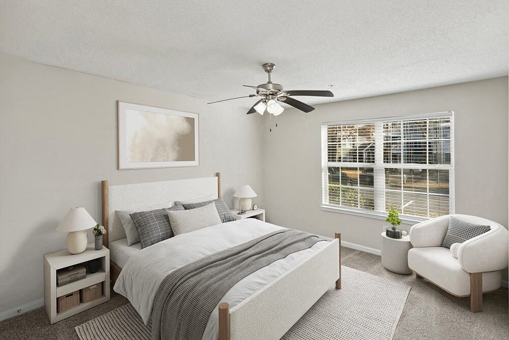Model Bedroom with Carpet and Window View at Shadow Ridge Apartments in Riverdale, GA.