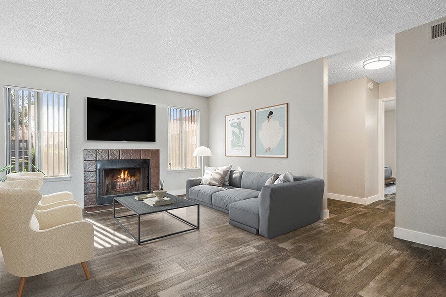 Model Living Room with Wood-Style Flooring and Fireplace at Peaks on 4th Apartments in Avondale, AZ.