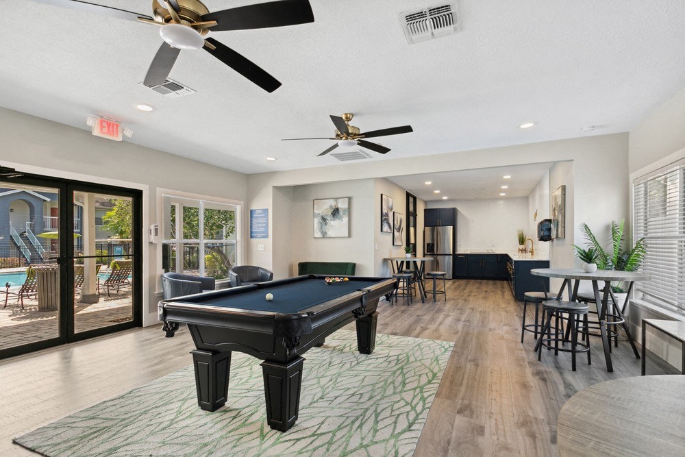 Community lounge with billiards table at Retreat at Crosstown Apartments