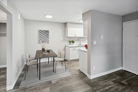 an open kitchen and dining room with a table and chairs
