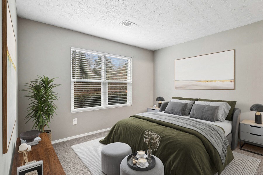 model apartment bedroom with a bed and a window