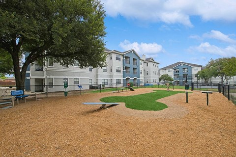 Community Dog Park with Agility Equipment at Hidden Creek Apartments located in Lewisville, TX.