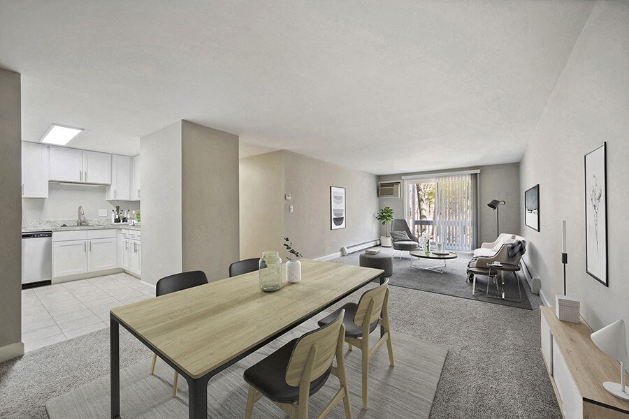 Model Living Room with Carpet and View of Kitchen/Dining Area at Middlesex Crossing Apartments in Billerica, MA.