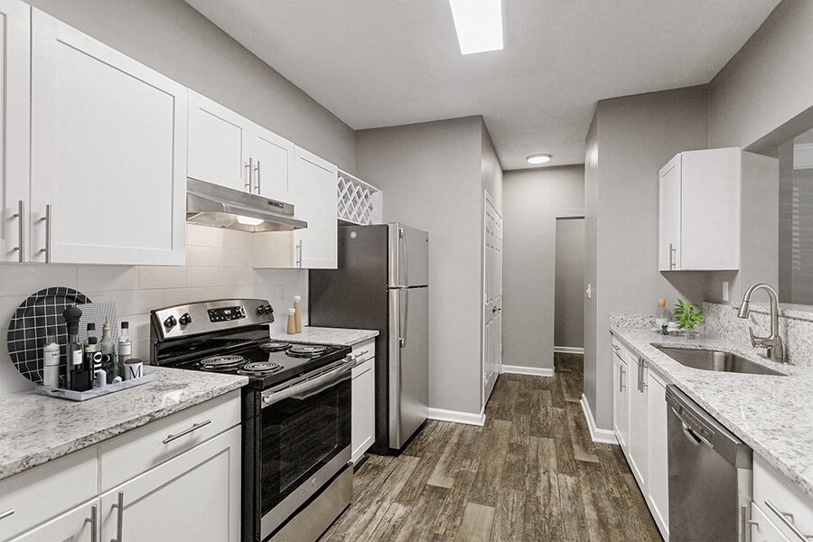 Model Kitchen with White Cabinets and Wood-Style Flooring at Parkside at Town Center Apartments in Marietta, GA.