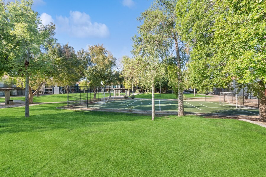 Green lawns and trees around the apartments at Verona Park, Mesa, AZ 85210