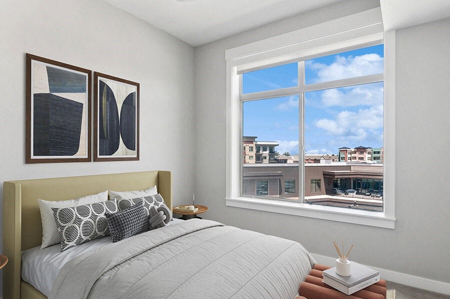 Model Bedroom with Carpet and Window View at Seven Skies Apartments located in Sandy, UT.