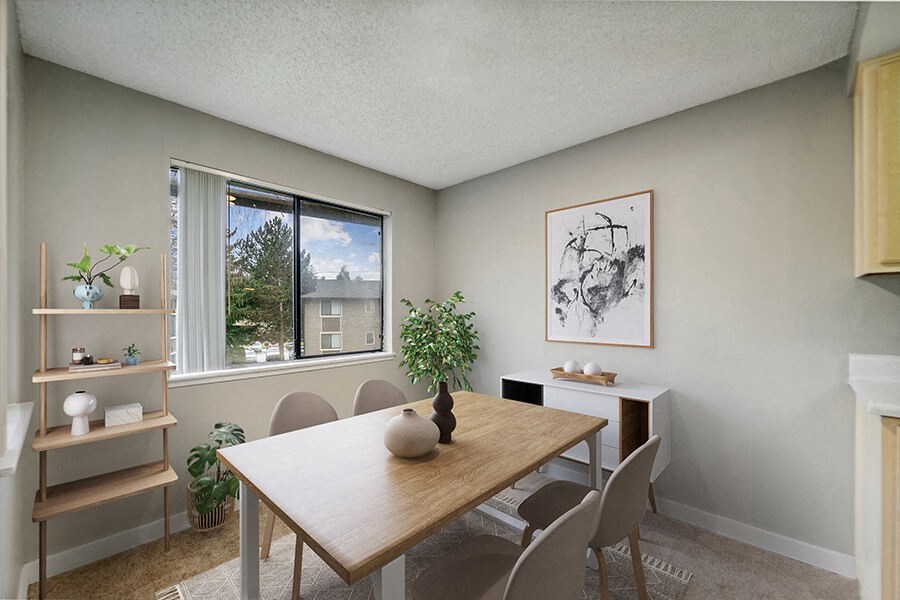 Model Dining Room with Carpet and Window View at Grammercy Apartments located in Renton, WA.