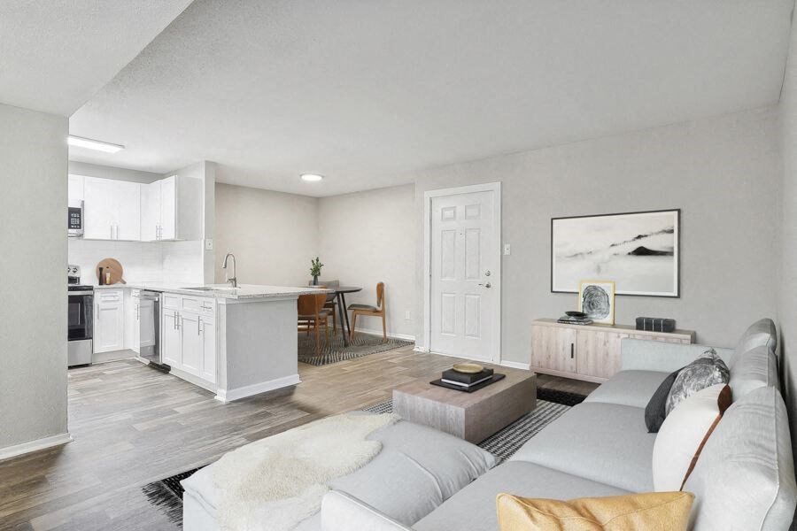 a living room with a couch and a kitchen