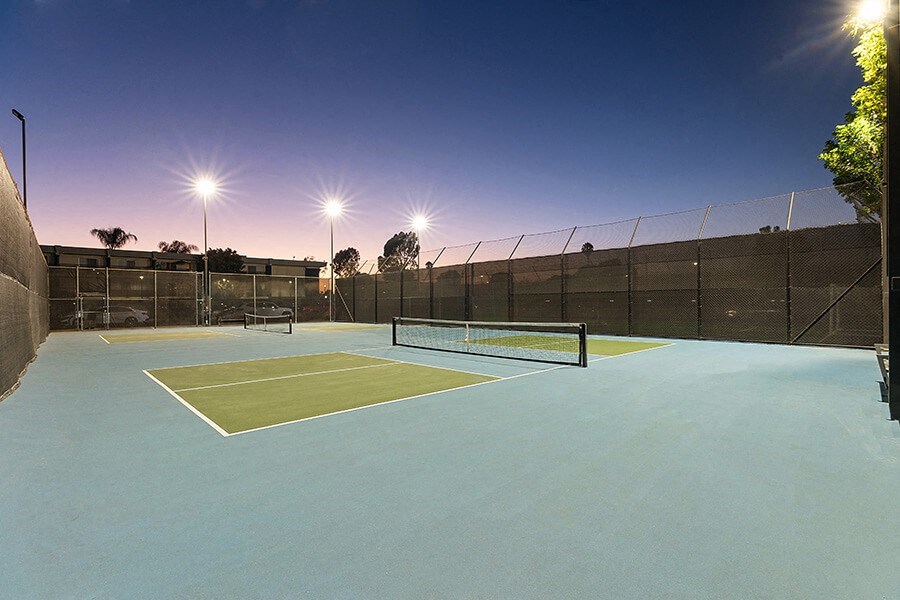 Community Tennis Court with Nets at Madison Park Apartments located in Anaheim, CA.