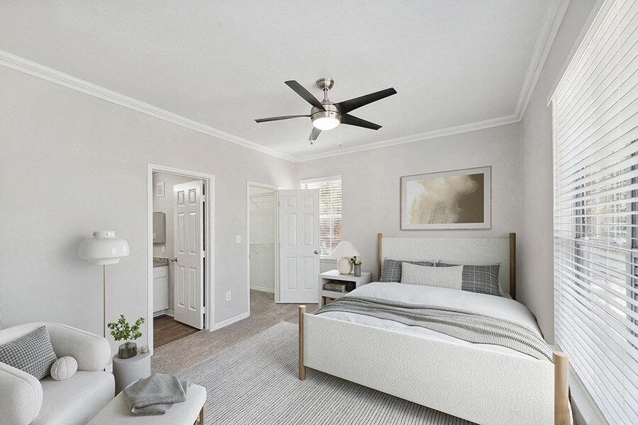 Model Bedroom with Carpet and attached Bathroom at Chapel Hill Apartments in Lewisville, TX.