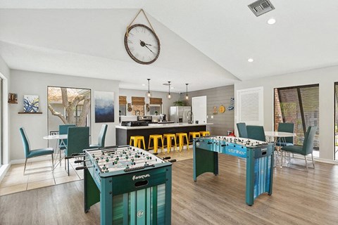 Community Clubhouse with Kitchenette and Game Tables at Grand Pavilion Apartments in Tampa, FL.