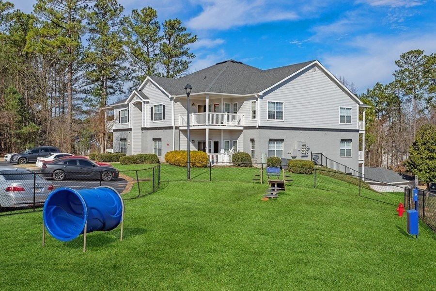 Fenced in dog park with agility equipment