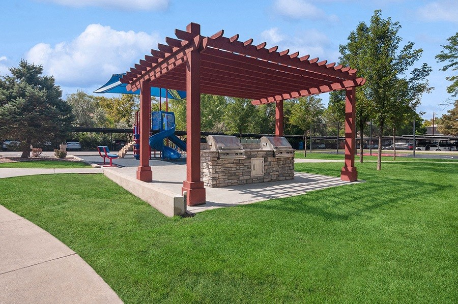 Outdoor BBQ Area & Playground View at Monaco Apartments in Salt Lake City, UT.
