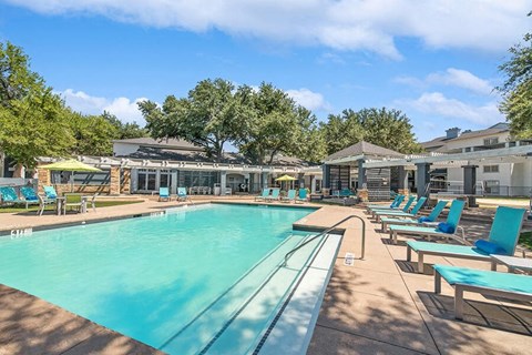 Community Swimming Pool with Pool Furniture at Allure North Dallas Apartments in Dallas, TX.