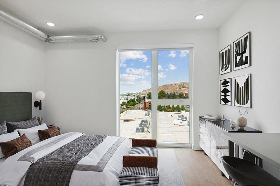 Model bedroom with large windows at 801 Flats located in Post District Residences in downtown Salt Lake City, Utah