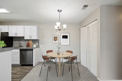 a kitchen and dining room with a table and chairs