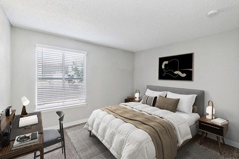 Northeast Albuquerque, NM, Apartments with In-Unit Washer and Dryer - Indigo Park - Cozy Bedroom With Upholstered Bed, Neutral Bedding, Desk Workspace, And Wide Window With White Blinds.