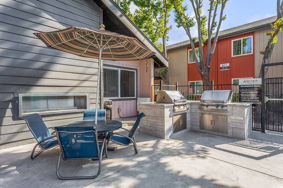 Outdoor BBQ Area with Furniture at The Archer Apartments in Sacramento, CA.
