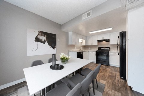 an open kitchen and dining room with a white table and chairs