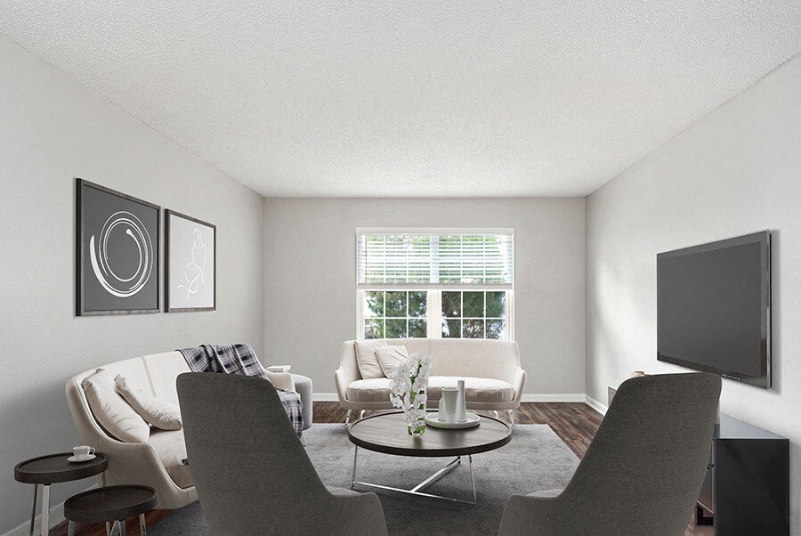 Model Living Room with Wood-Style Flooring and Window View at Commons at Haynes Farm Apartments in Shrewsbury, MA.