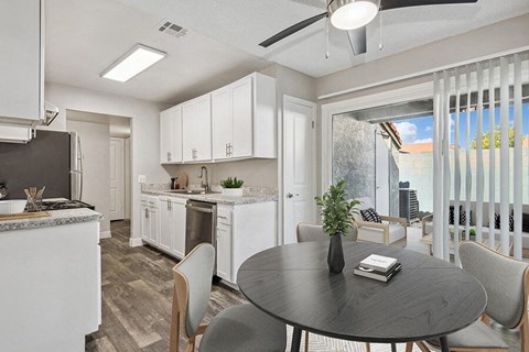 an open kitchen and dining area with a table and chairs