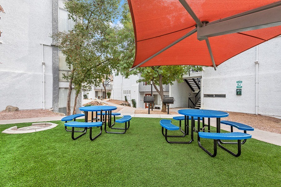 Outdoor Pic Nic Area with Tables and Orange Canopy at Crystal Creek Apartments in Phoenix, AZ.
